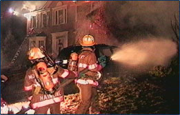 Graphic showing firefighters spraying water on a fire