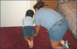 Graphic showing a child and  an adult crawling on the floor