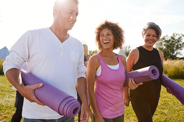 people carrying yoga mats